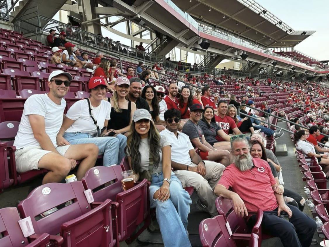 The Ample team together in the stands at a Reds game